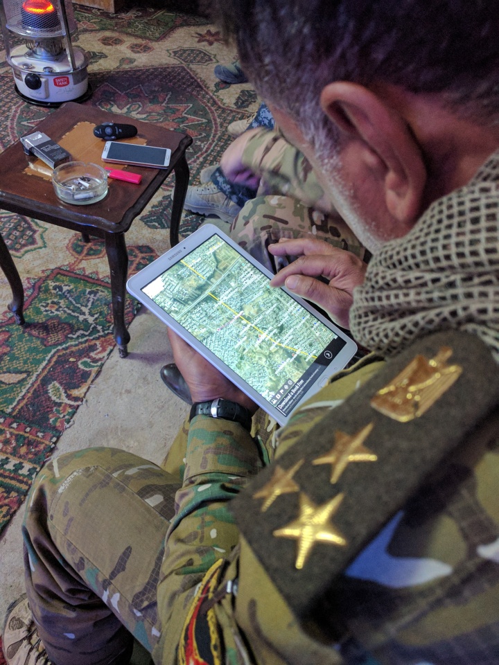 Gen. Abbas studying tablet computer